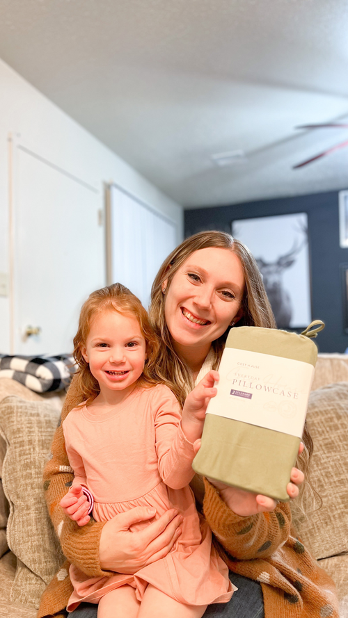 A mother and her daughter holding a packaged pair of 100% Bamboo pillowcases.
