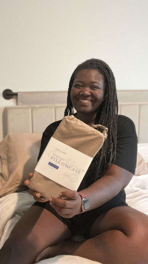 A very happy customer showing her packaged pair of 100% Bamboo pillowcases.